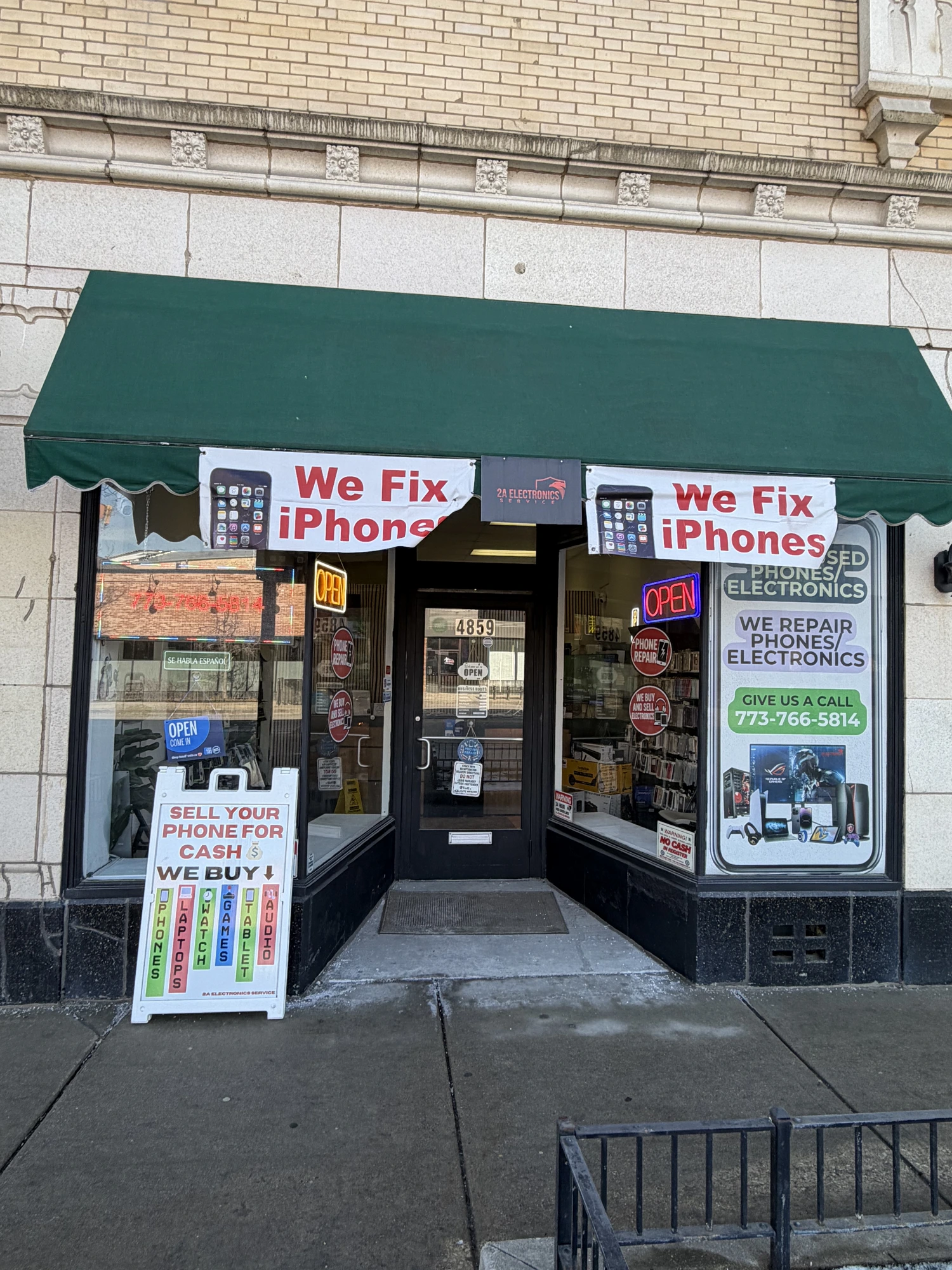 2A Electronics store entrance with 'We Fix iPhones' banners in Chicago