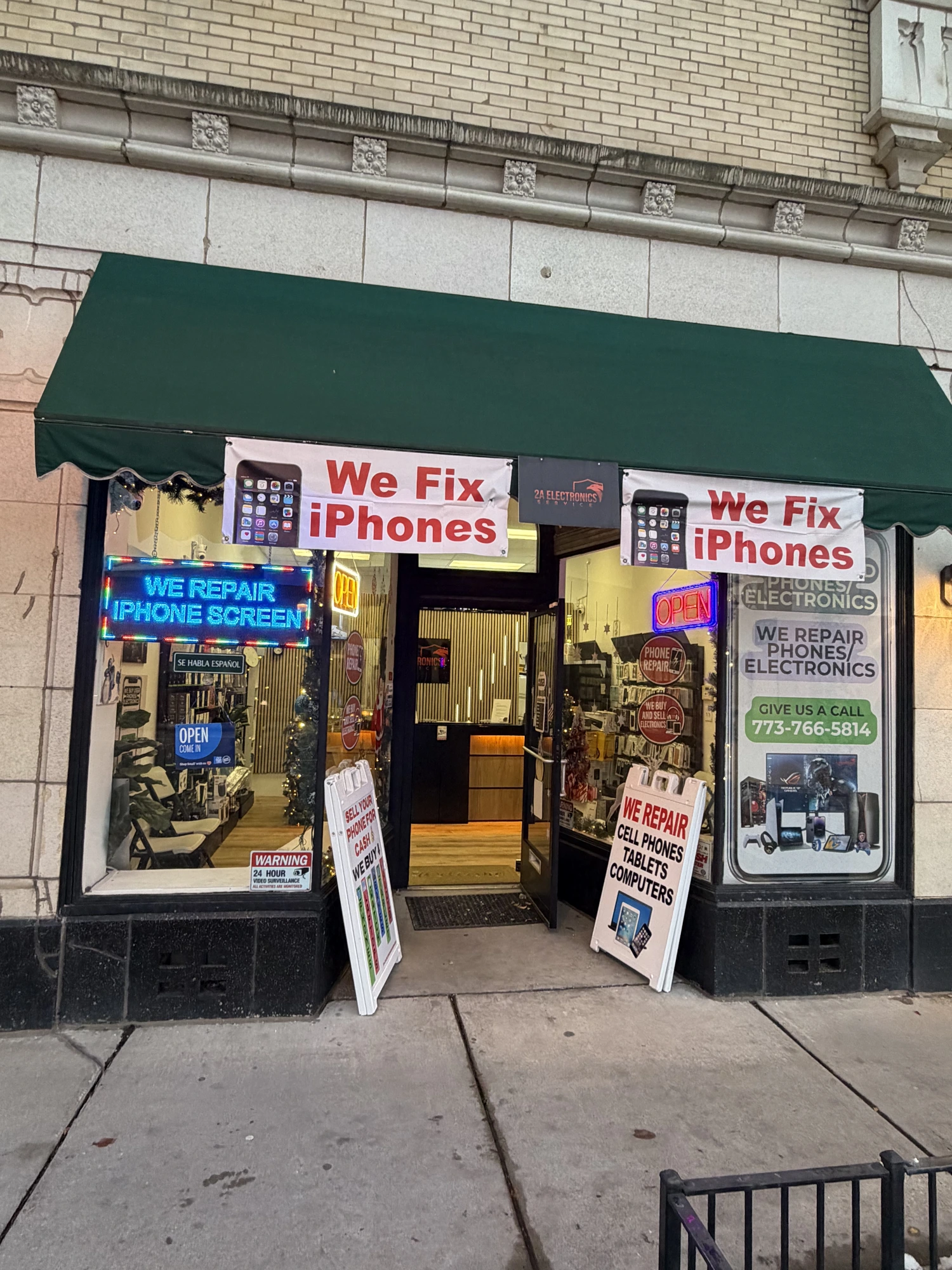 2A Electronics storefront with green awning at 4859 W Irving Park Rd, Chicago