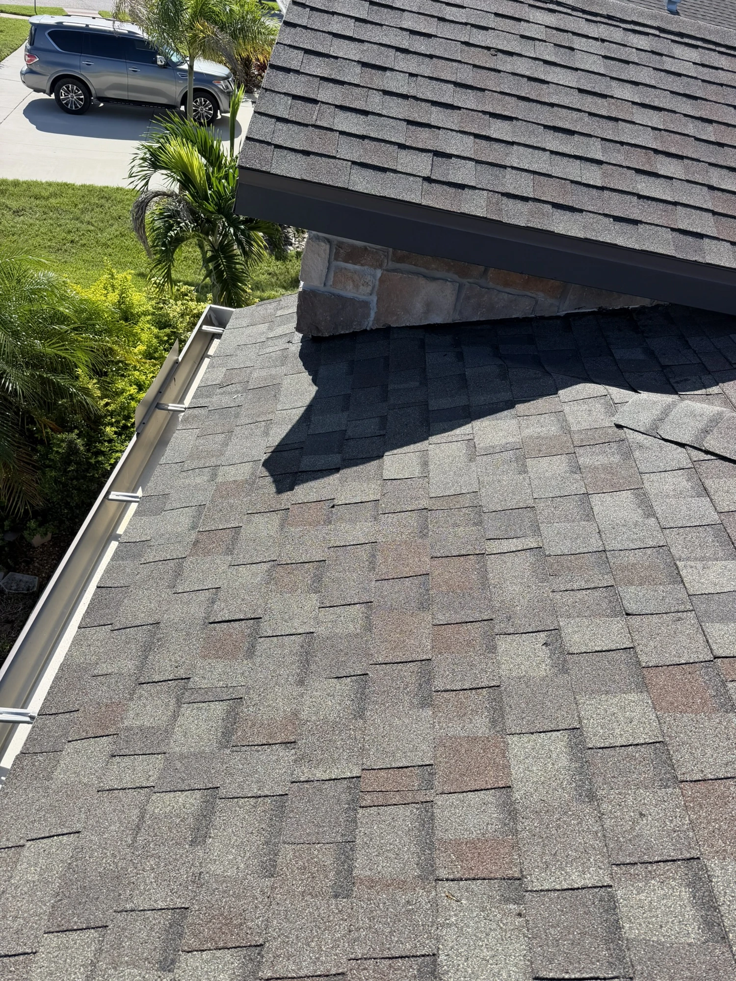 completed architectural shingle roof repair around a chimney in Riverview FL