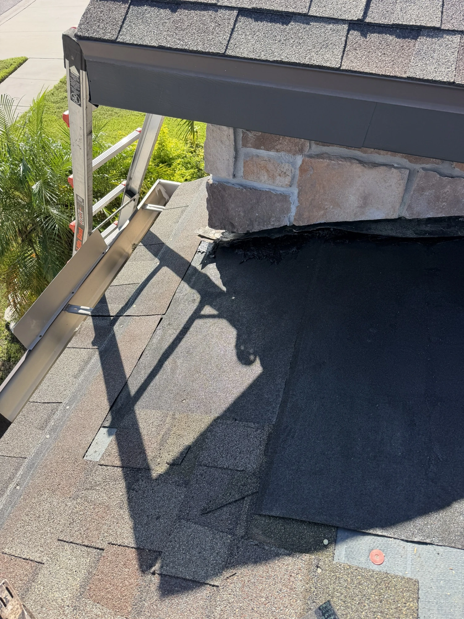 self-adhering underlayment tied into existing shingles at the roof edge