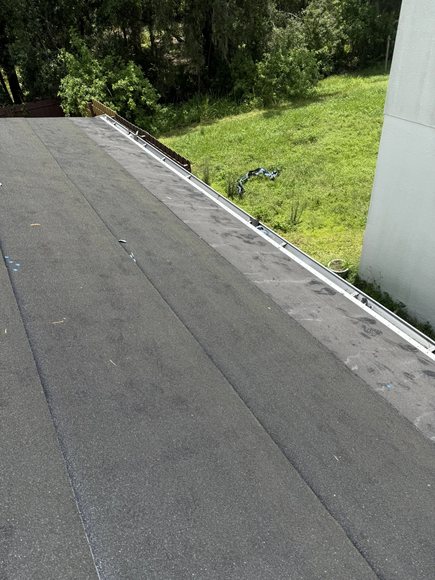peel-and-stick underlayment and new drip edge installed on a Riverview roof before shingles