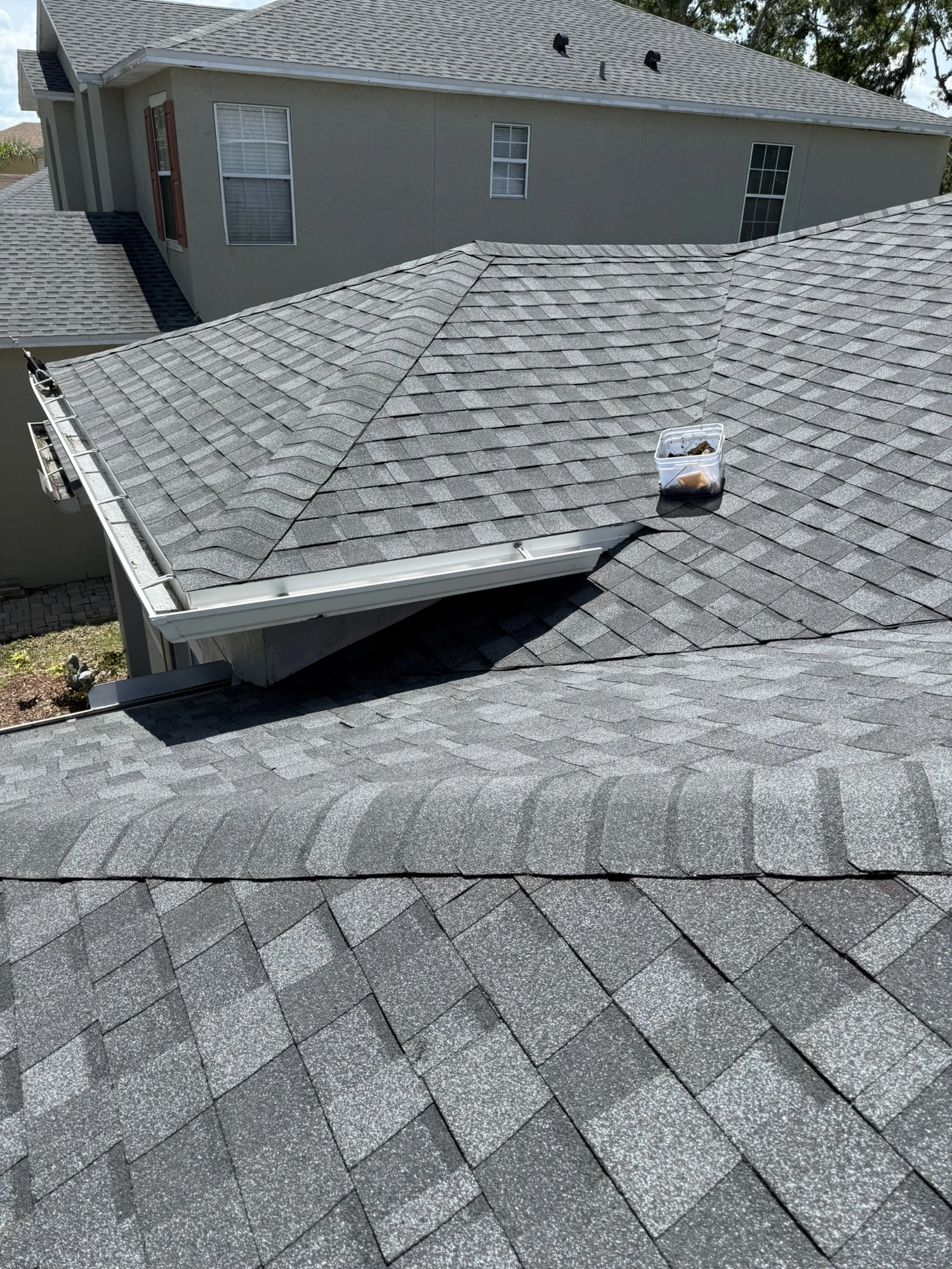 completed gray architectural shingle roof with hips and ridge caps on a Riverview home