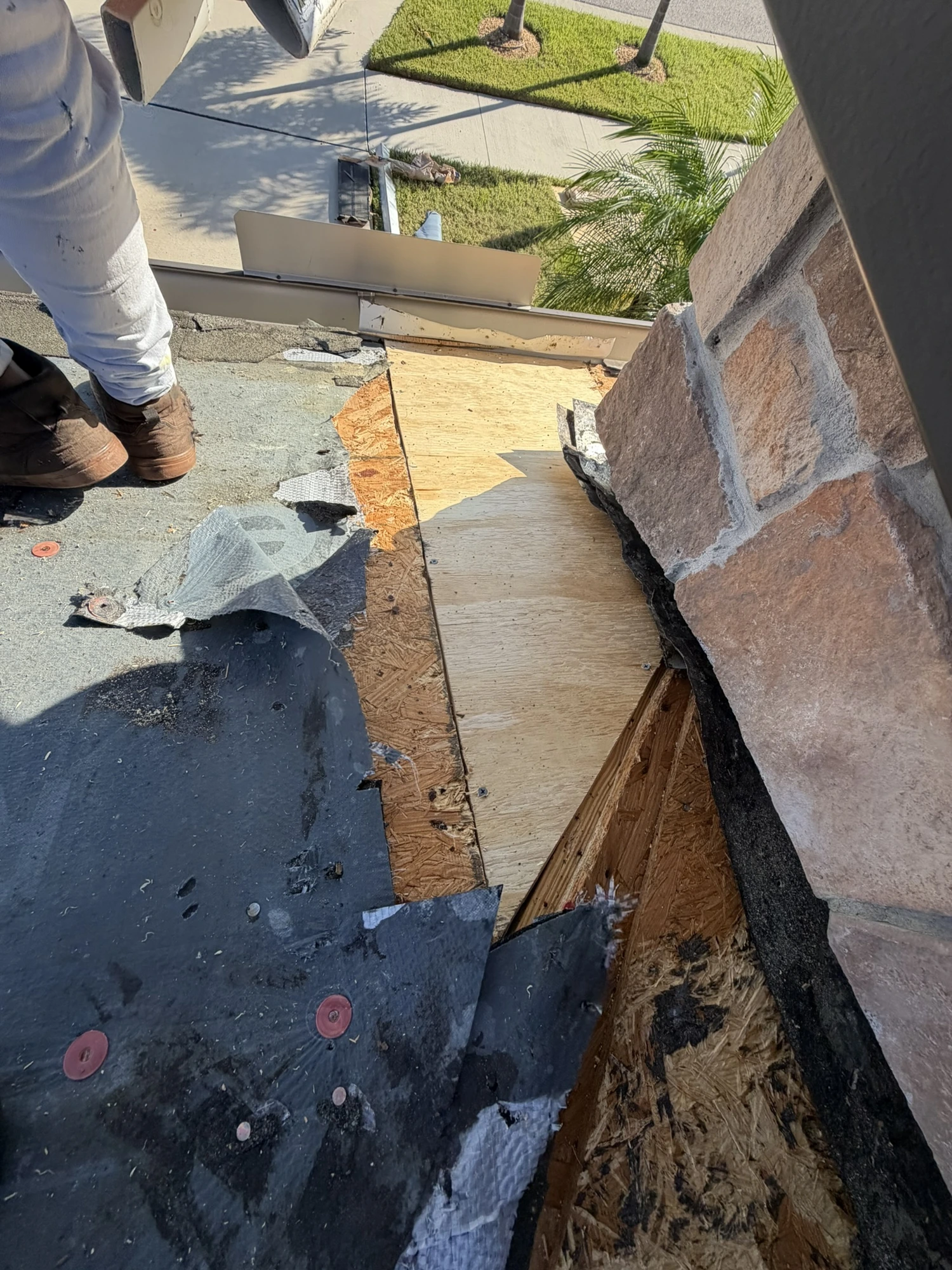 new plywood roof decking installed next to a chimney in Riverview