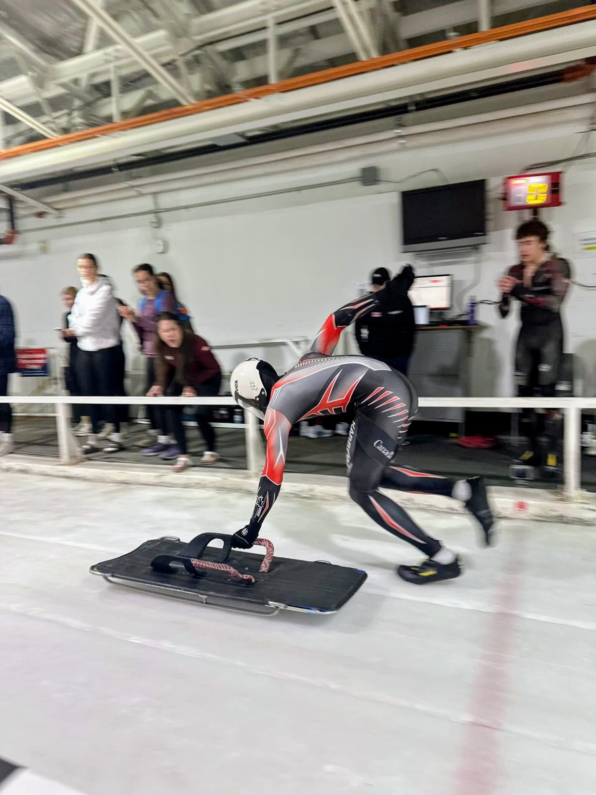 Ethan Phillips pushing his skeleton sled at the start of a training run
