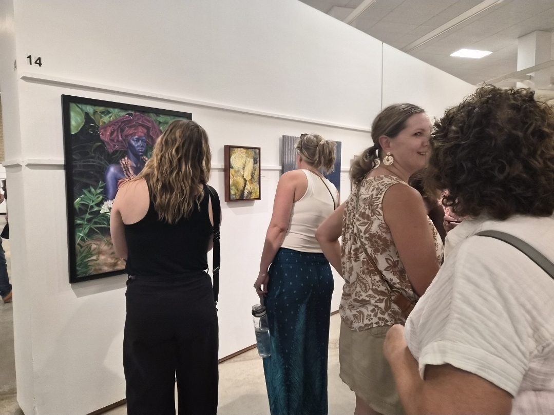 Visitors viewing a large portrait painting in the Minnesota State Fair gallery