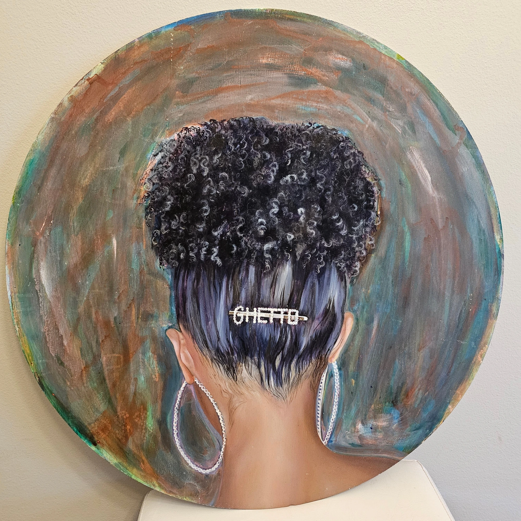 Circular artwork detail showing a hair clip spelling GHETTO