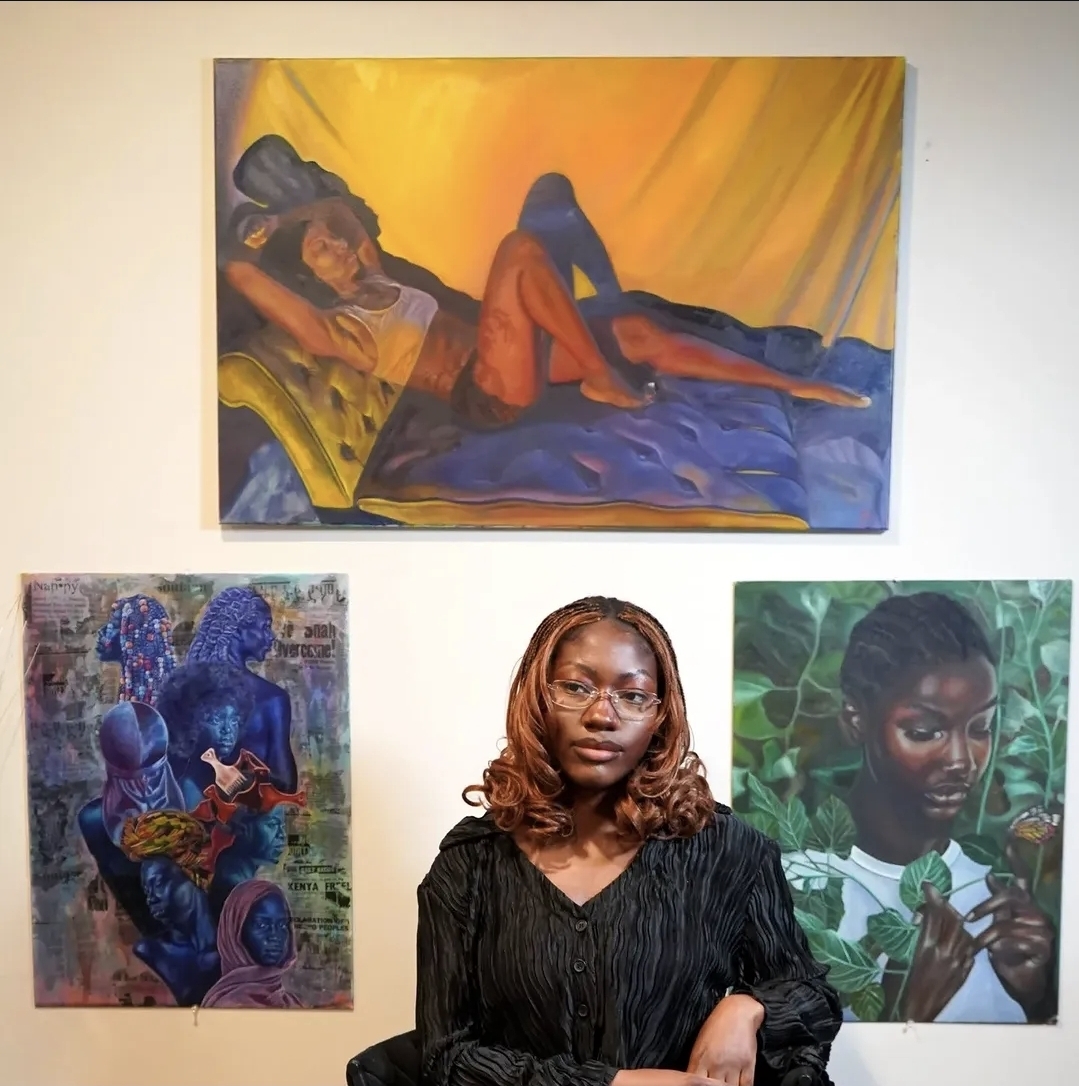 Love Quetee in the studio surrounded by paintings in progress