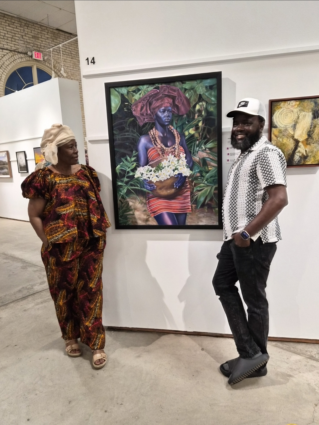 Visitors standing beside a large framed painting at the Minnesota State Fair