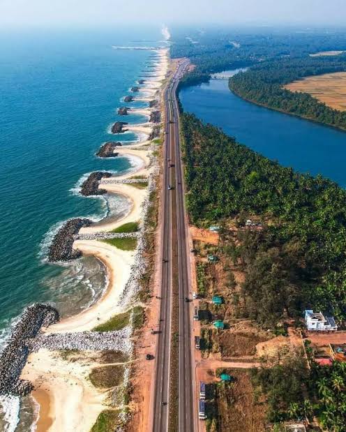 Aerial view of Maravanthe Beach — NH66 between the Arabian Sea and Souparnika river