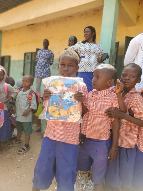 A student shows off his new backpack to his classmates