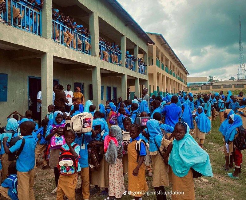 School outreach day — students gathered with their new backpacks